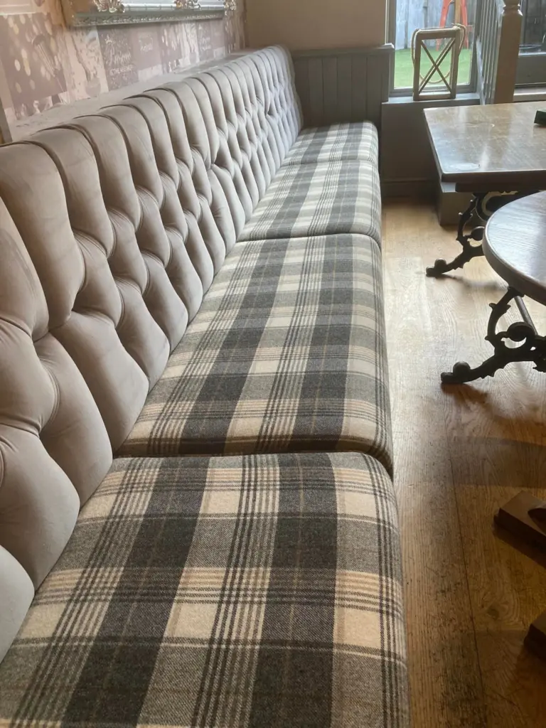 Upholestry cleaning - a large grey sofa cleaned
